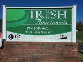Mcewen apartment for rent - a sign apartments in front of a brick wall